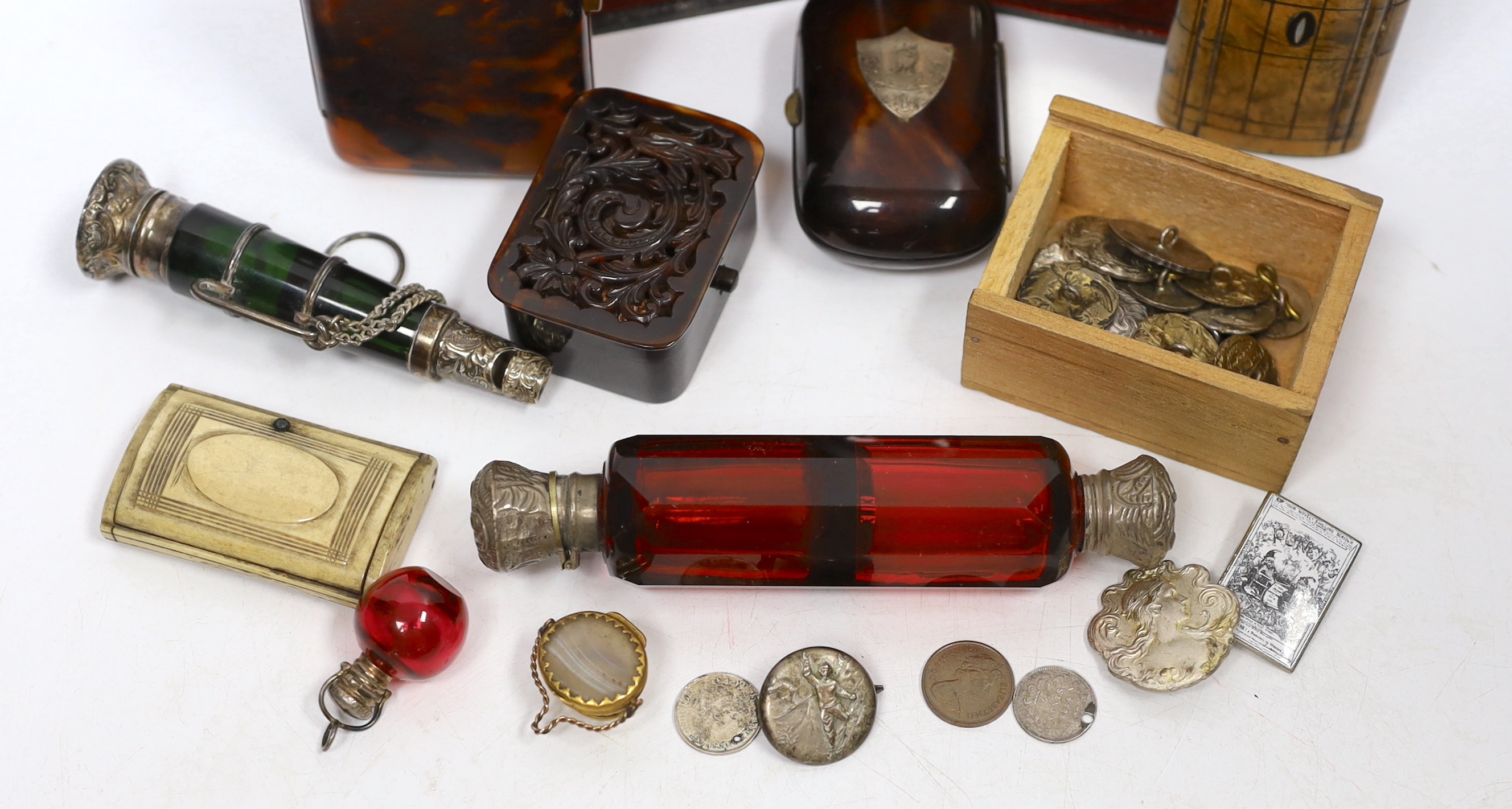 A group of vertu to include an unusual Victorian white metal mounted green glass combination scent bottle and whistle, a group of Art Nouveau silver buttons, carved tortoiseshell boxes, a double ended scent bottle etc.